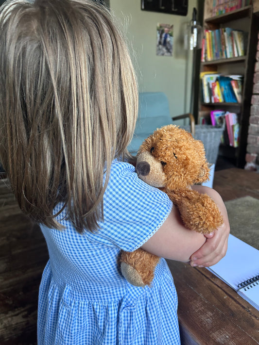 Child holding a Name Your Bear part of Wild Hearts Creative kits, worry and comfort bear