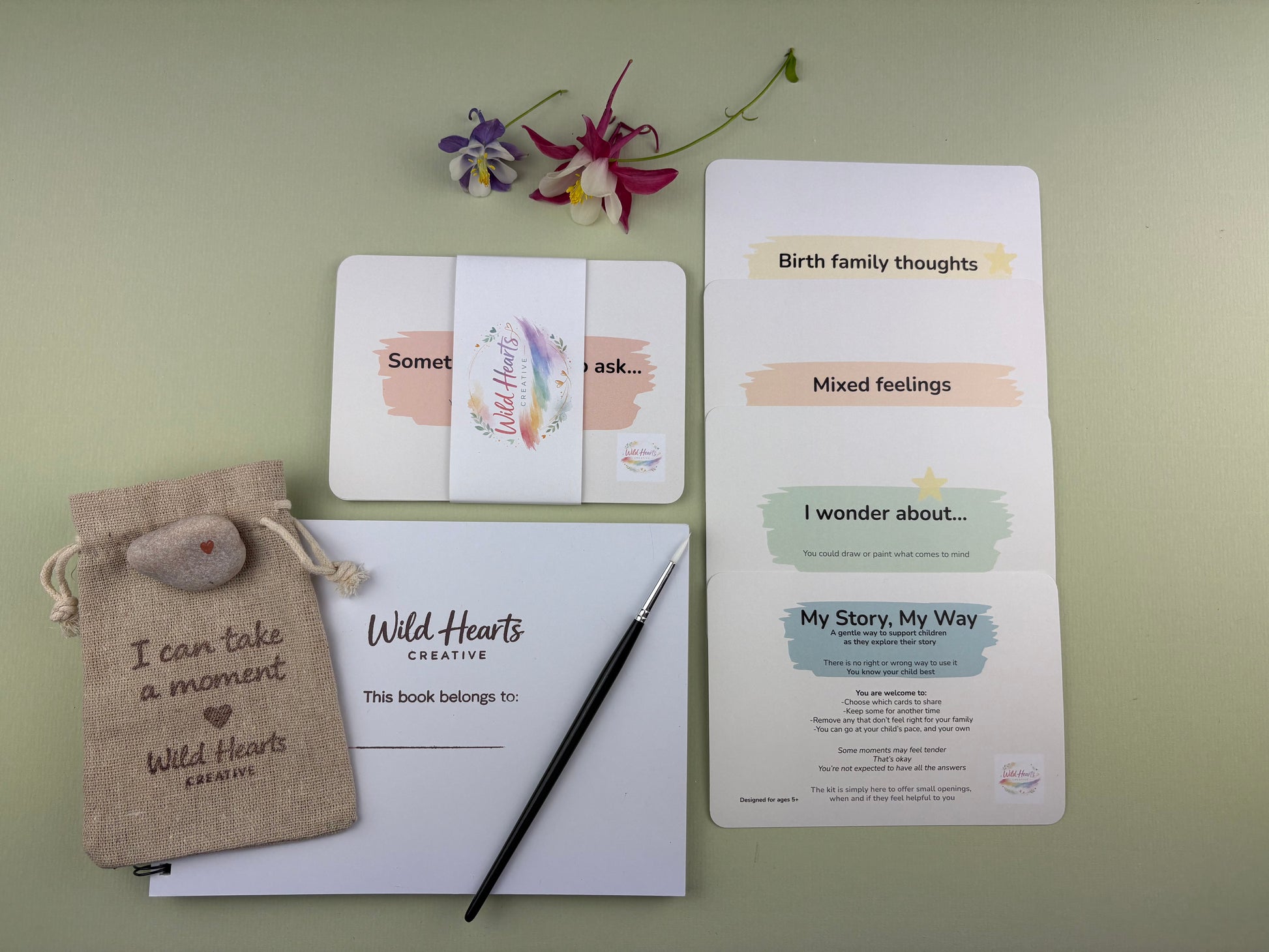 Flat lay of the My story, my way adoption life story identity creative support kit for children, featuring prompt cards, comfort stones, creative resources and comfort items designed to support emotional wellbeing.