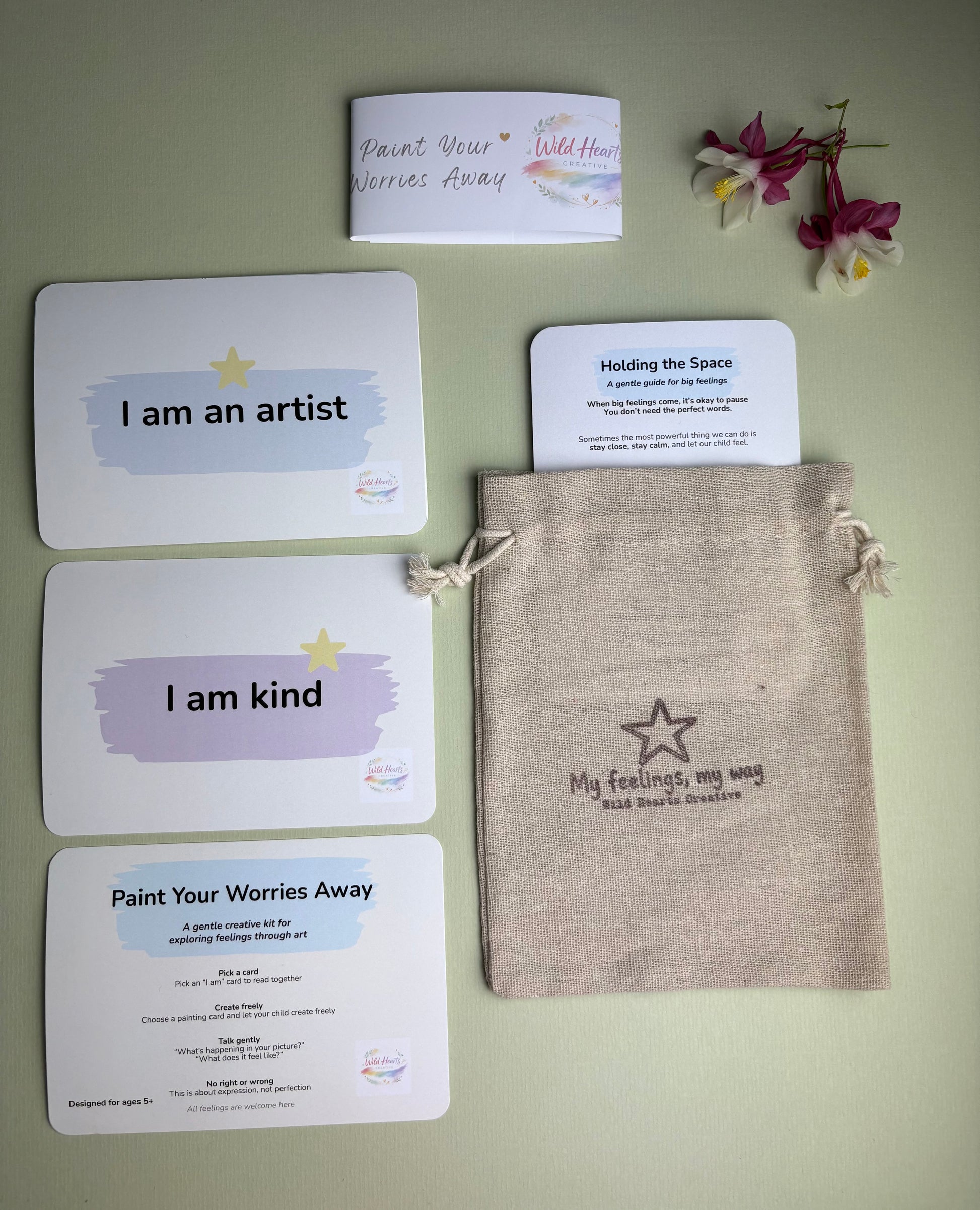 Wild Hearts Creative Paint Your Worries Away kit featuring creative reflection cards, affirmation cards, a Holding the Space guide and drawstring pouch. Designed to help children explore worries, anxiety and big feelings through painting, creativity and gentle conversation.