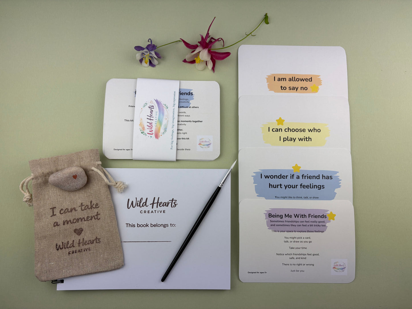 Flat lay of the Being Me With Friends creative support kit for children, featuring prompt cards, comfort stones, creative resources and comfort items designed to support emotional wellbeing.