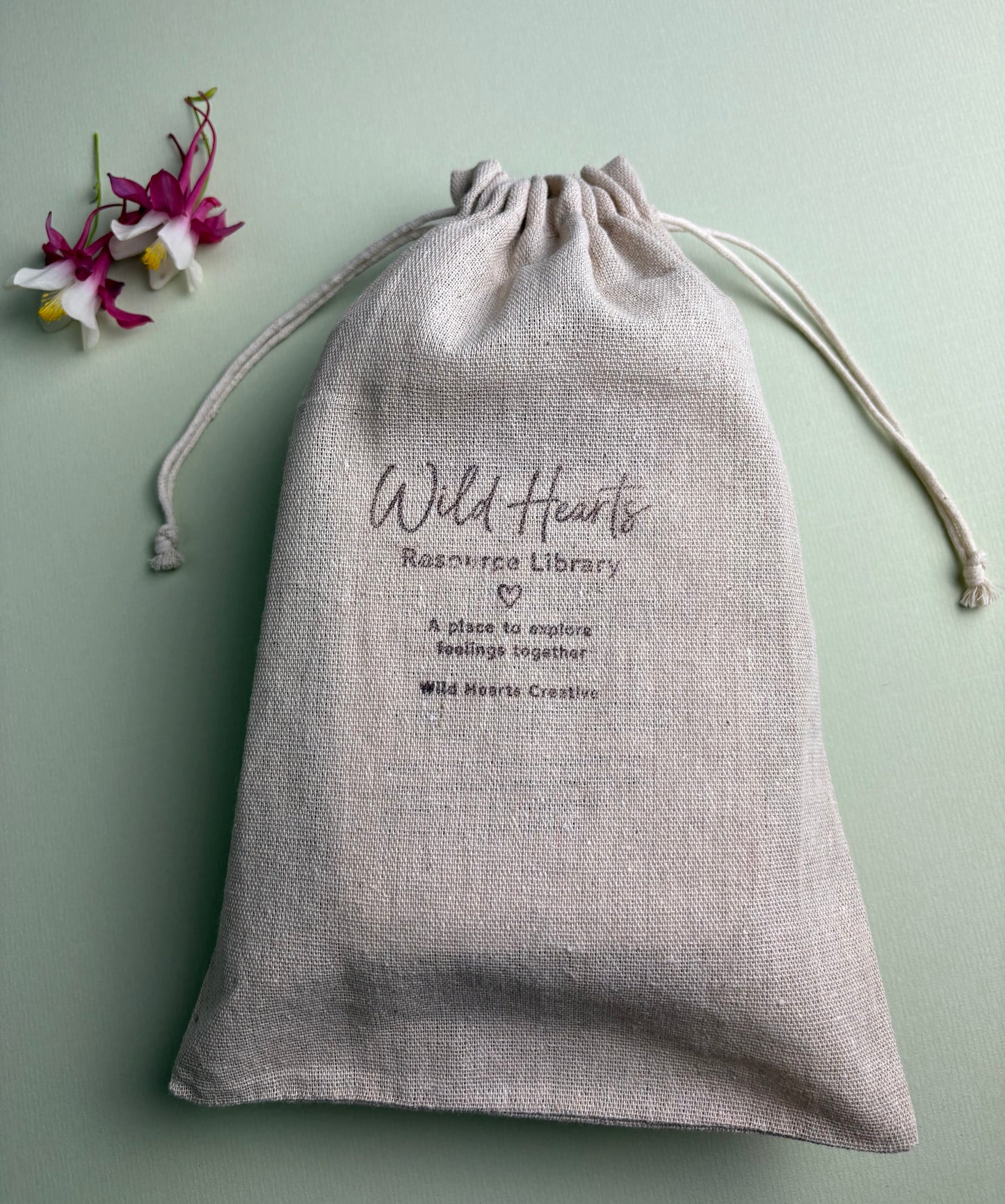 Wild Hearts Creative Resource Library drawstring bag containing emotional literacy, wellbeing and reflection card resources for schools.