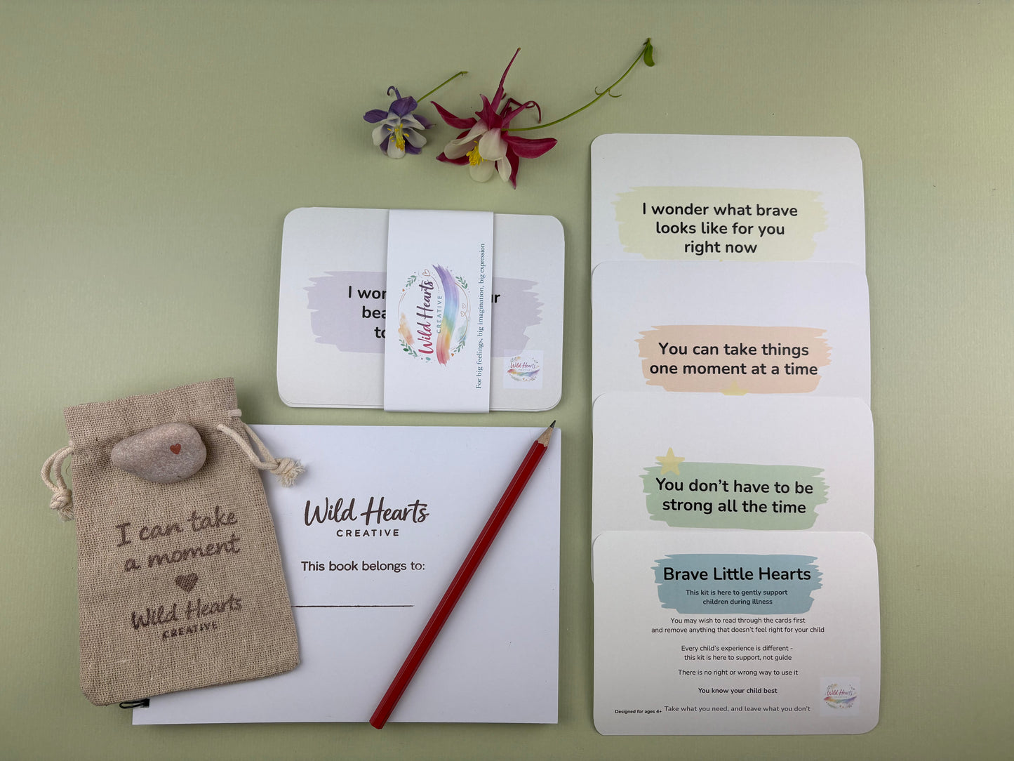 Flat lay of the Brave Little Hearts hospital stays creative support kit for children, featuring prompt cards, comfort stones, creative resources and comfort items designed to support emotional wellbeing.