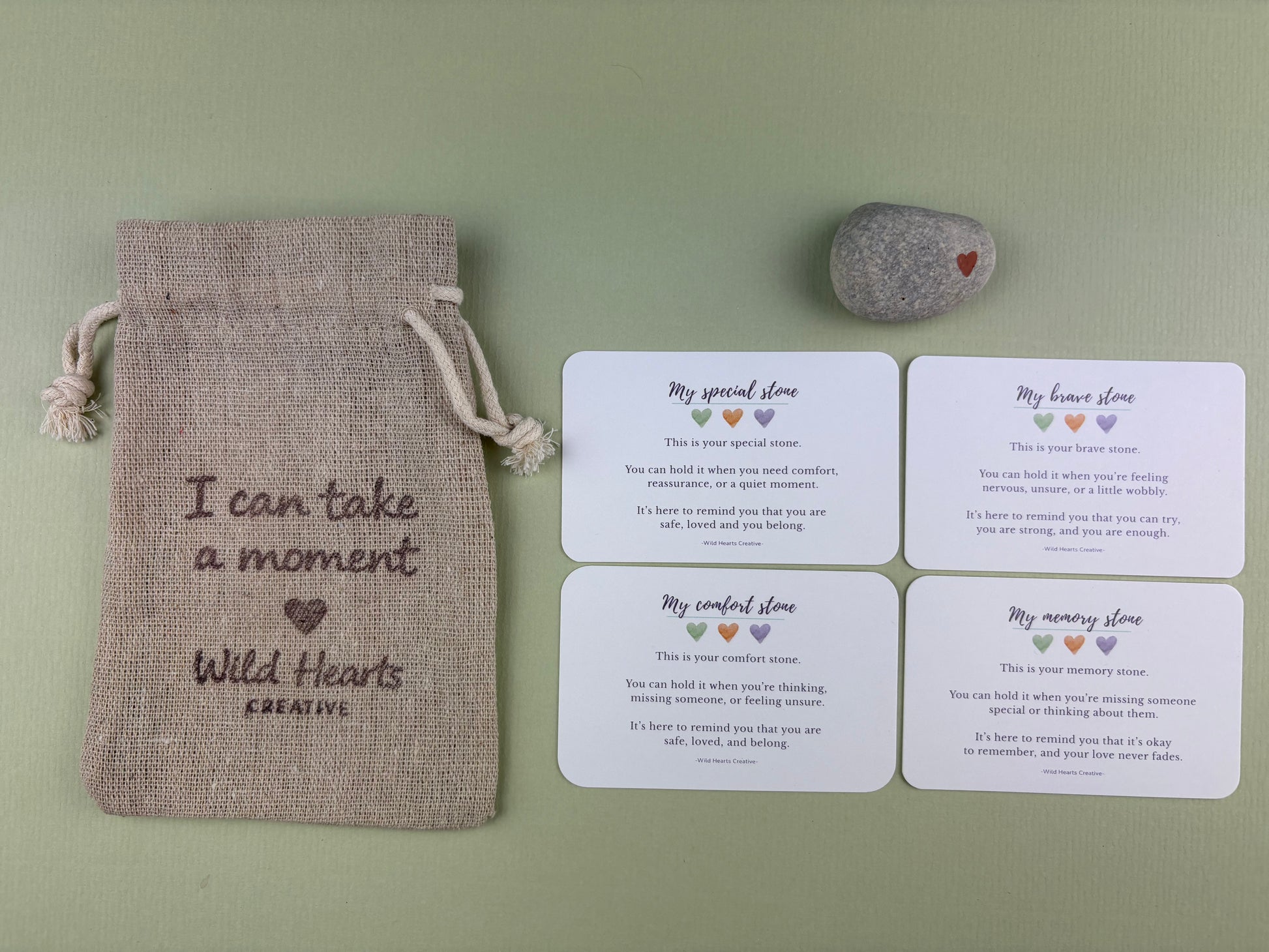 Collection of Wild Hearts Creative comfort stones with reassurance cards and a drawstring pouch, designed to provide calm, comfort and emotional support for children during challenging moments.