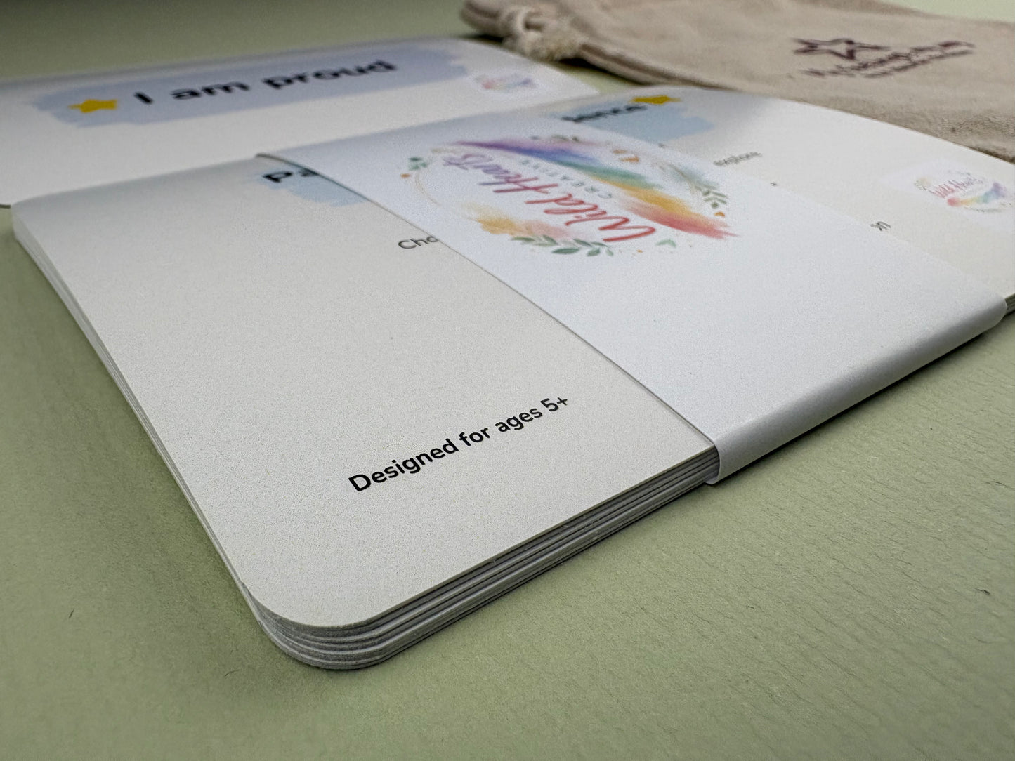 Close-up of a Wild Hearts Creative card collection secured with a branded belly band, showcasing high-quality rounded cards designed to support children’s emotional wellbeing through creative prompts and affirmations.