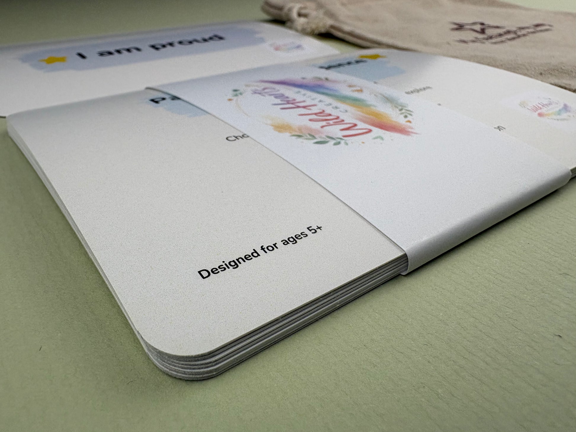 Close-up of a Wild Hearts Creative card collection secured with a branded belly band, showcasing high-quality rounded cards designed to support children’s emotional wellbeing through creative prompts and affirmations.