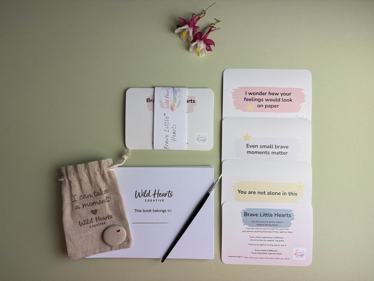 Wild Hearts Creative Brave Little Hearts support kit featuring reflection cards, creative prompts, sketchbook, comfort stone and drawstring pouch. Designed to help children prepare for hospital appointments, medical procedures, treatment and healthcare experiences through gentle conversation and creative expression.
