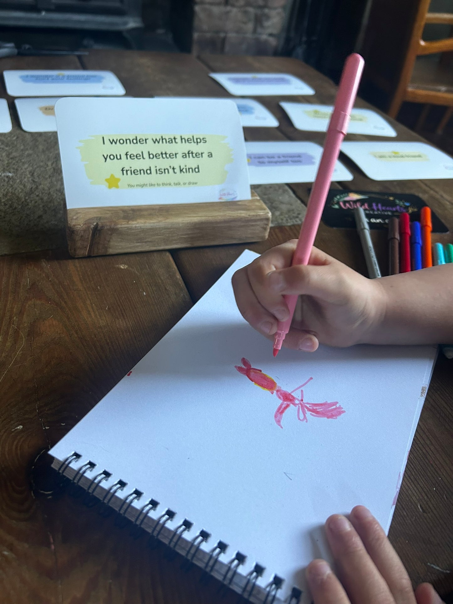 Child creatively processing feelings on sketchbook, with Being Me With Friends, Affirmation Prompts by Wild Hearts Creative