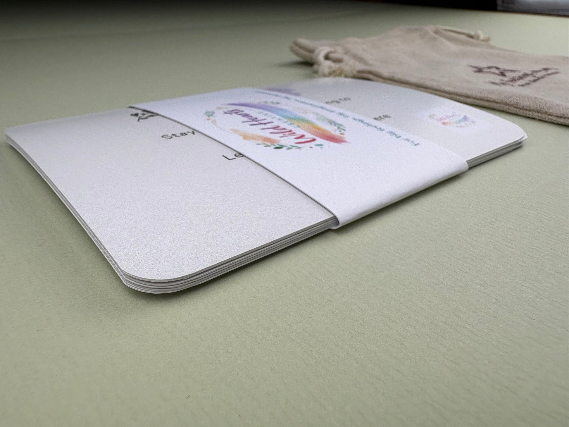 Close-up of a Wild Hearts Creative card collection secured with a branded belly band, showcasing high-quality rounded cards designed to support children’s emotional wellbeing through creative prompts and affirmations.
