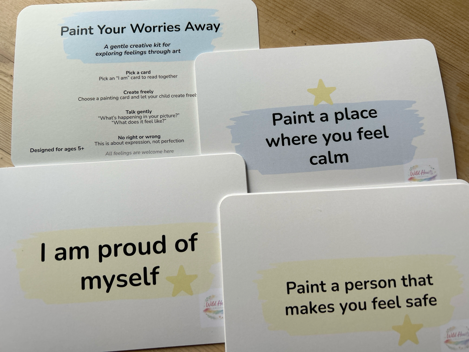 Set of high quality rounded cards for children with affirmations for paint your worries away kit for emotional expression on a wooden surface