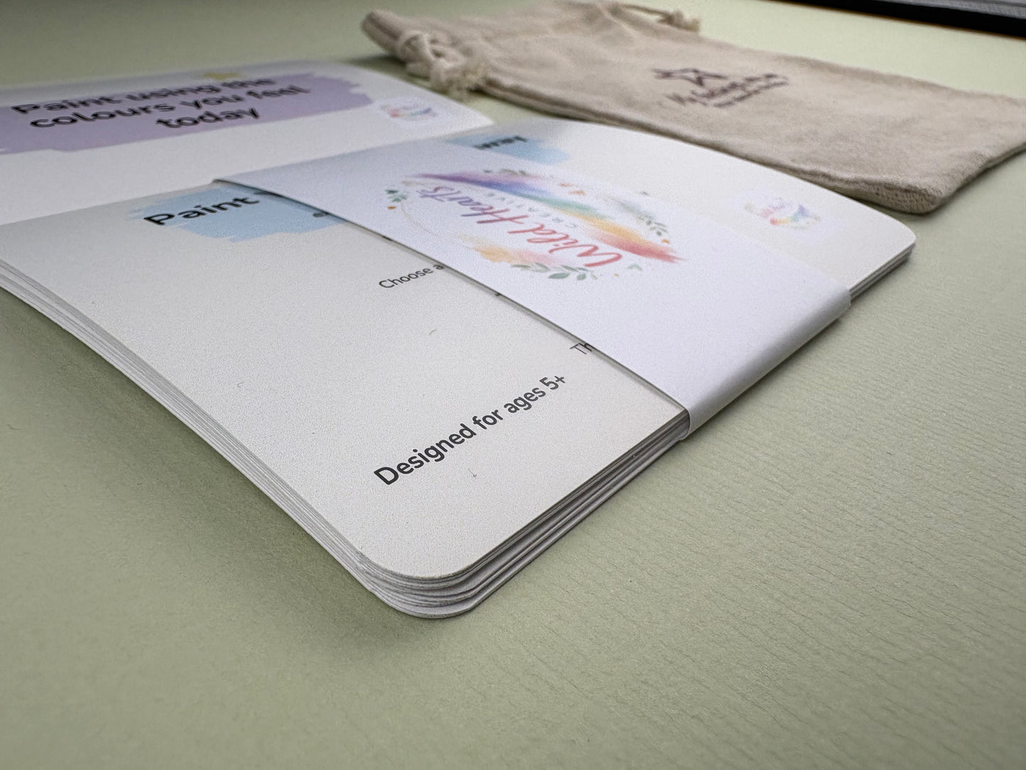 Close-up of a Wild Hearts Creative card collection secured with a branded belly band, showcasing high-quality rounded cards designed to support children’s emotional wellbeing through creative prompts and affirmations.