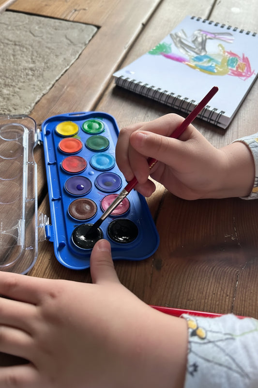 Child carefully selecting colours to paint emotions and big feelings, wild hearts creative, more than words
