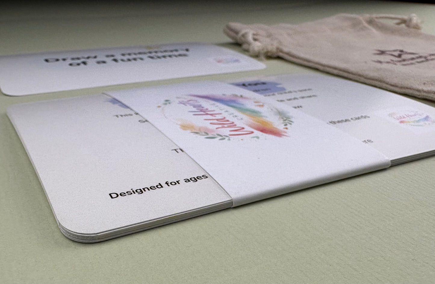 Close-up of a Wild Hearts Creative card collection secured with a branded belly band, showcasing high-quality rounded cards designed to support children’s emotional wellbeing through creative prompts and affirmations.