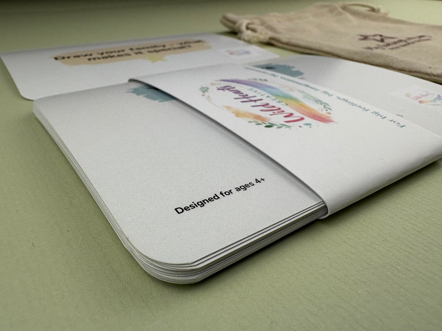 Close-up of a Wild Hearts Creative card collection secured with a branded belly band, showcasing high-quality rounded cards designed to support children’s emotional wellbeing through creative prompts and affirmations.