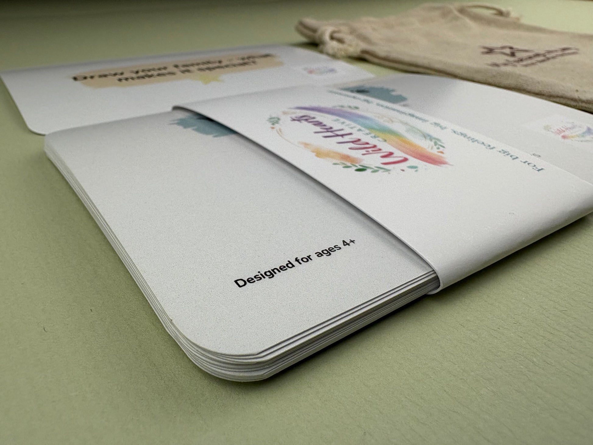 Close-up of a Wild Hearts Creative card collection secured with a branded belly band, showcasing high-quality rounded cards designed to support children’s emotional wellbeing through creative prompts and affirmations.
