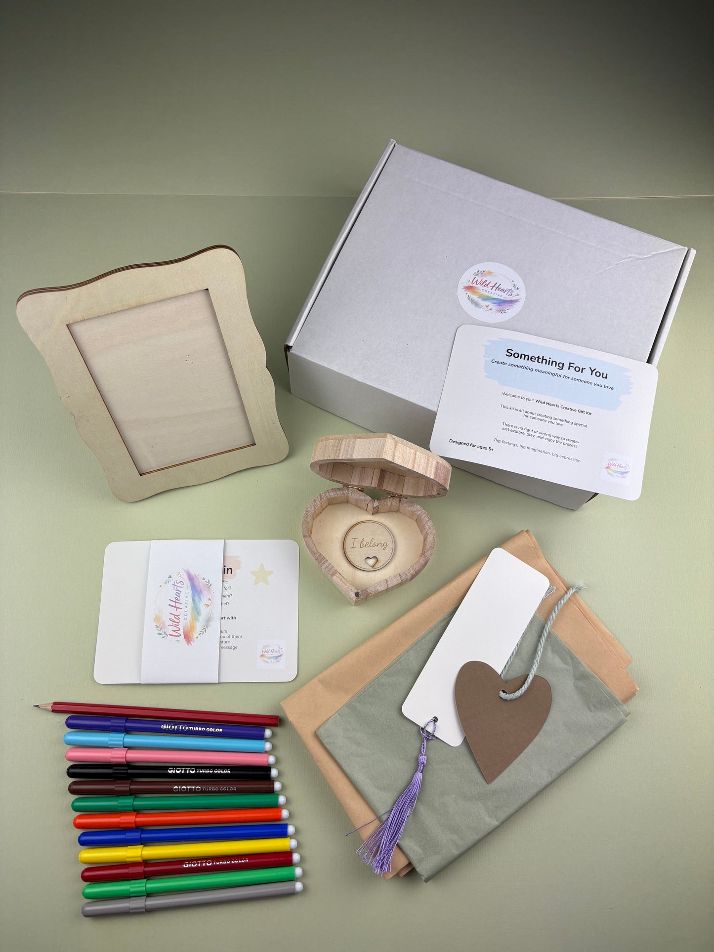 Creative keepsake kit for children with activity cards, pens, photo frame, wooden heart box, bookmark and craft materials for making meaningful gifts and memories. Packaging box with logo