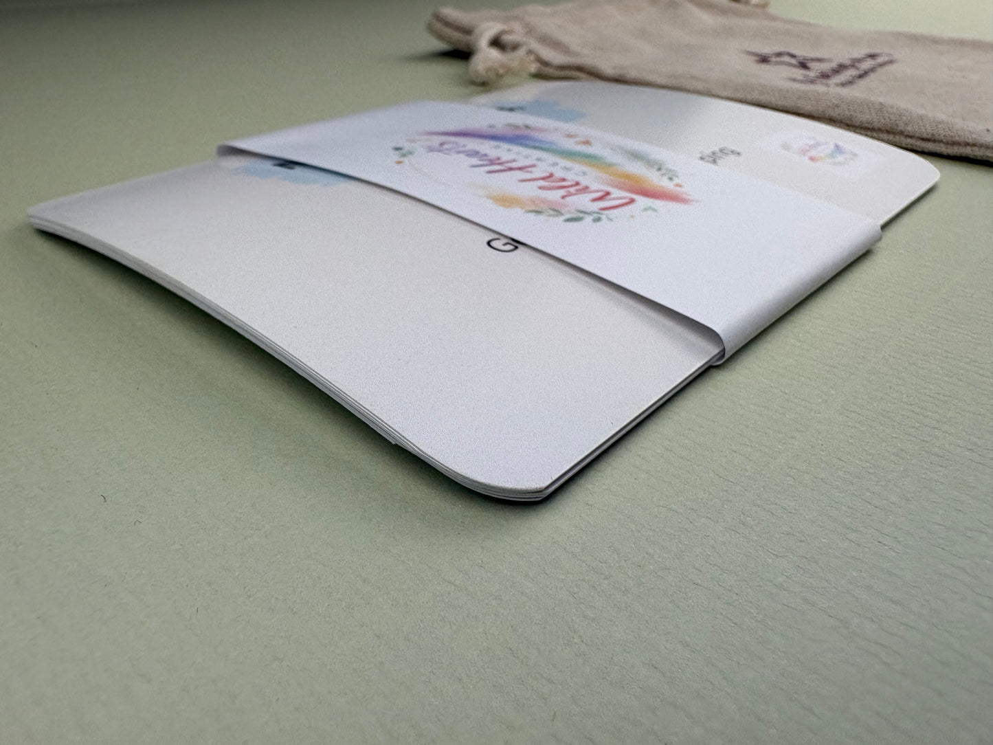 Close-up of a Wild Hearts Creative card collection secured with a branded belly band, showcasing high-quality rounded cards designed to support children’s emotional wellbeing through creative prompts and affirmations.