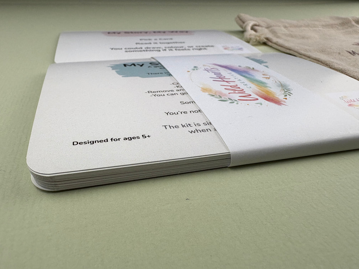 Close-up of a Wild Hearts Creative card collection secured with a branded belly band, showcasing high-quality rounded cards designed to support children’s emotional wellbeing through creative prompts and affirmations.