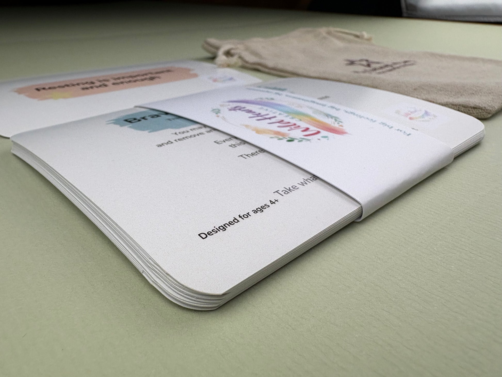 Close-up of a Wild Hearts Creative card collection secured with a branded belly band, showcasing high-quality rounded cards designed to support children’s emotional wellbeing through creative prompts and affirmations.