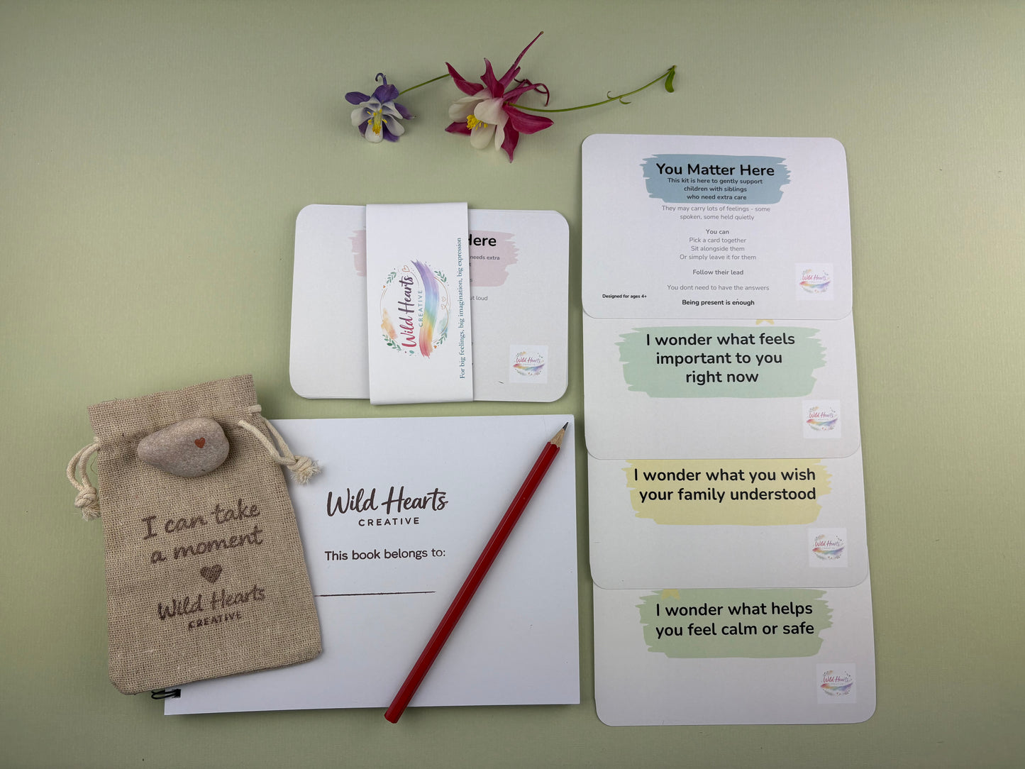 Flat lay of the You Matter Here creative support kit for children, featuring prompt cards, creative resources and comfort items designed to support emotional wellbeing.