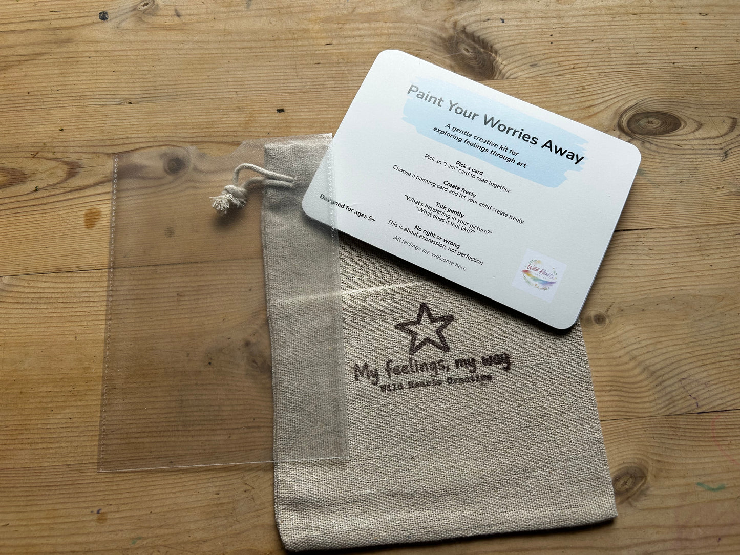 Textile bag with a star design and text, accompanied by a card on a wooden surface my feelings, my way by wild hearts creative
